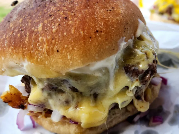 A double cheeseburger with melted cheese on a toasted bun, from Bock Burger.