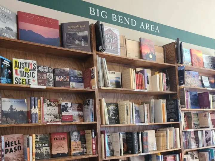 Shelves of books under a Big Bend Area sign inside Front Street Books.