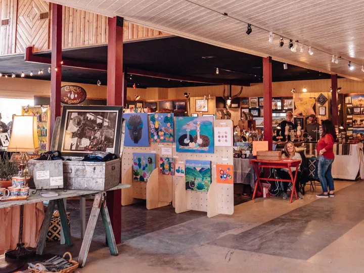 Art vendors' booths of paintings, photographs and crafts inside the Kishmish Plaza hall during Artwalk.